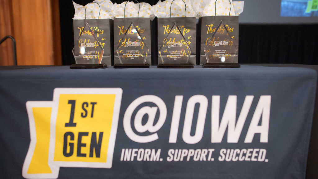 A table with decorative bags with the text "1stGen @ Iowa" on the table